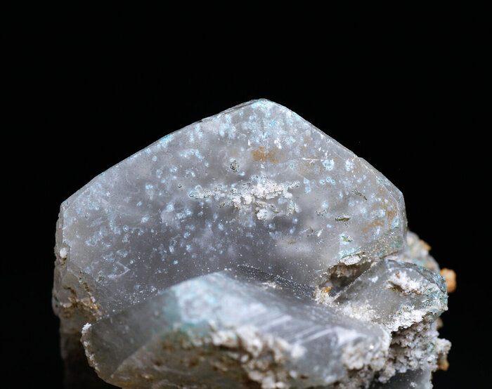 Кристалл серого кальцита с включениями серпьерита "в" и "на" поверхности кристалла.