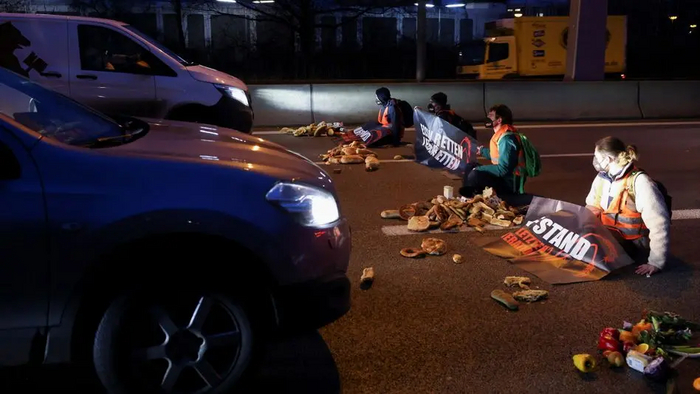Letzte Generation (Last Generation) activists block a highway to protest against food waste and for an agricultural change to reduce agricultural greenhouse gas emissions, in Berlin, Germany, February 4, 2022. REUTERS/Christian Mang