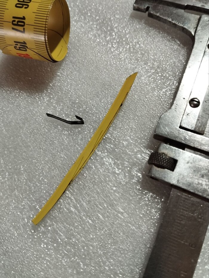сломанная прижимная пластина. вырезанная заготовка из рулетки.